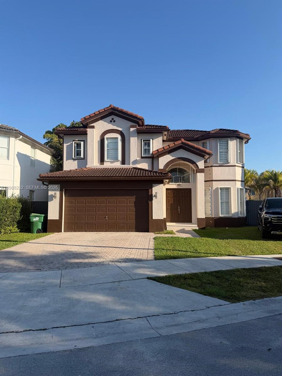 10837 Southwest 242nd Street Homestead, FL 33032 - Photo 1 of 19 a front view of a house with a yard