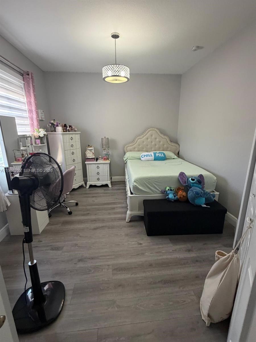 10837 Southwest 242nd Street Homestead, FL 33032 - Photo 15 of 19 a bed room with a bed