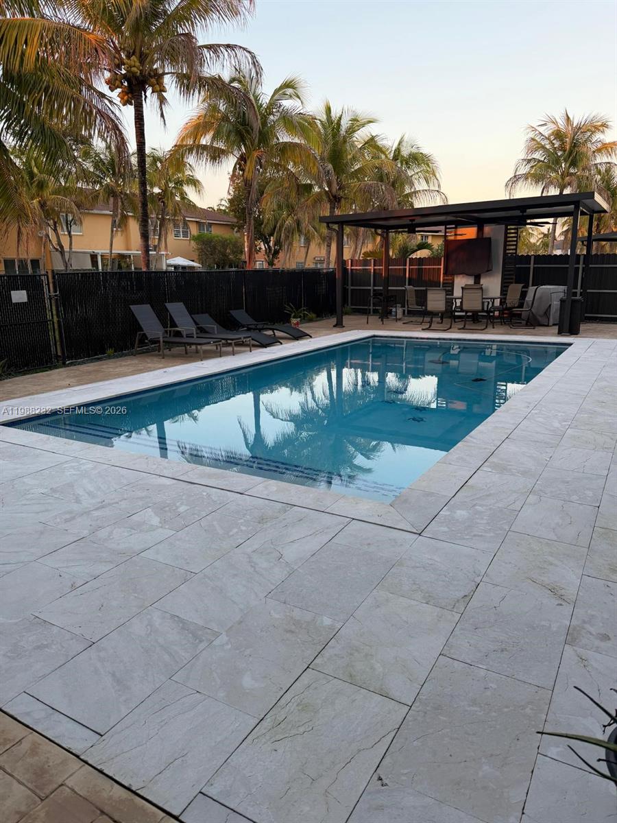 10837 Southwest 242nd Street Homestead, FL 33032 - Photo 16 of 19 a view of swimming pool with outdoor seating and city view