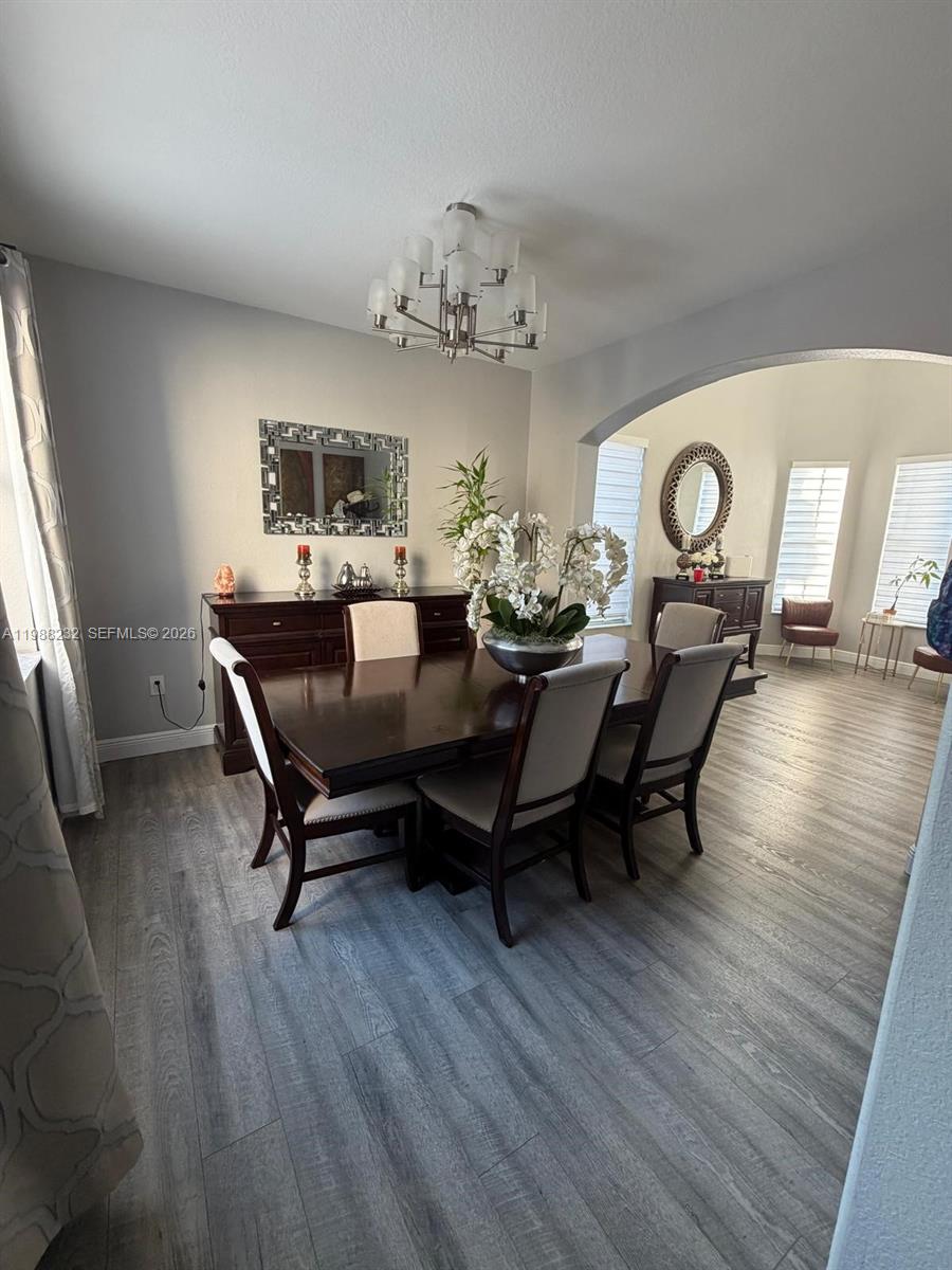 10837 Southwest 242nd Street Homestead, FL 33032 - Photo 2 of 19 a view of a dining room with furniture and a chandelier