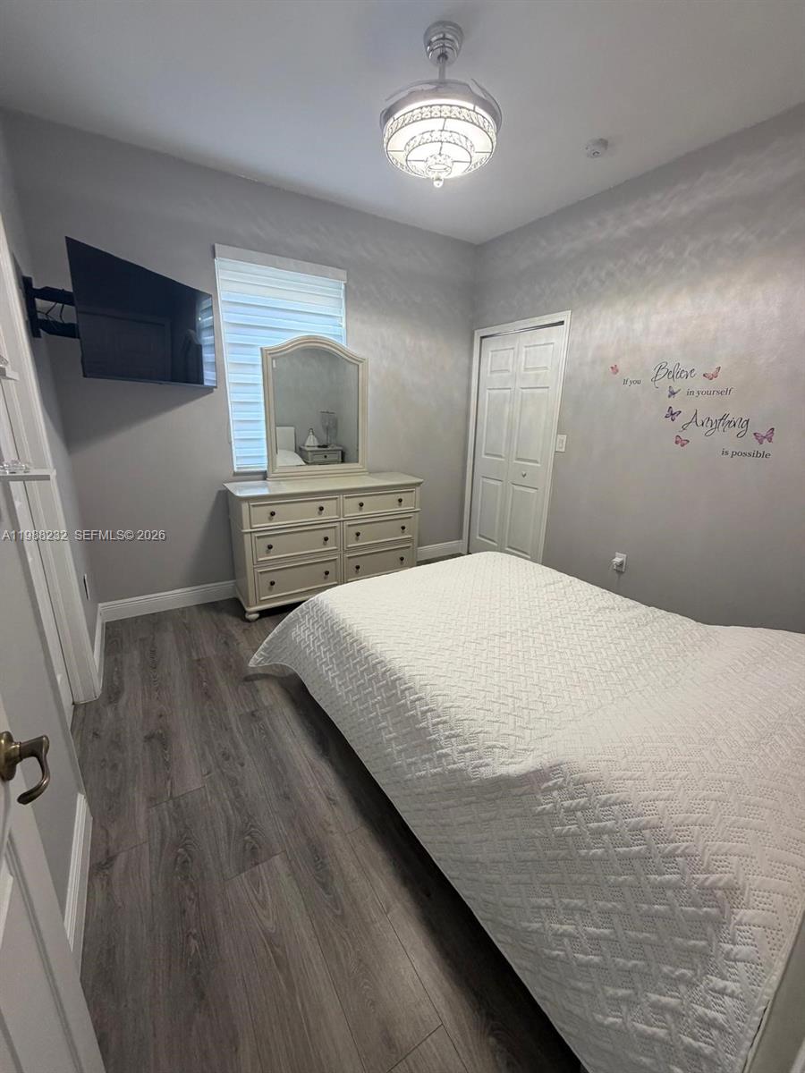 10837 Southwest 242nd Street Homestead, FL 33032 - Photo 8 of 19 a bedroom with a bed and a flat tv screen on dresser