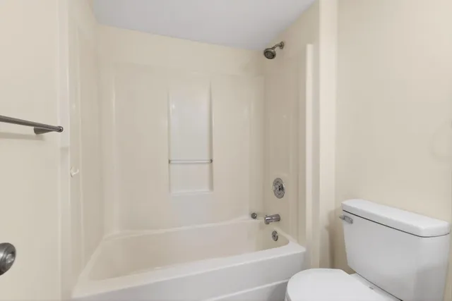a view of a room with wooden floor and windows
