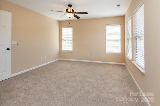 a view of room with a ceiling fan and window
