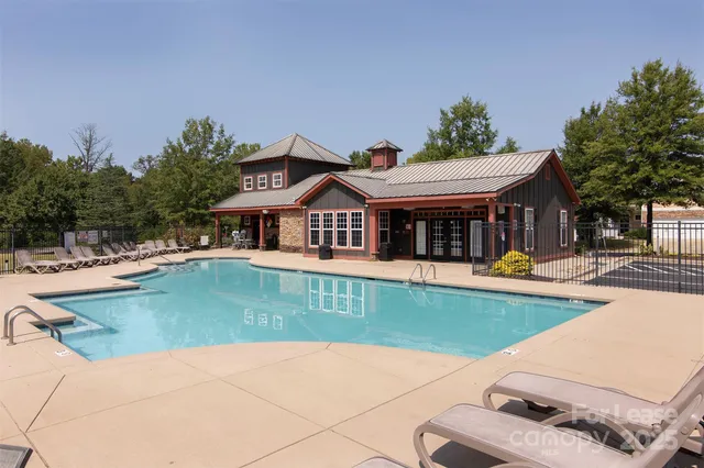 a view of a house with swimming pool and a yard