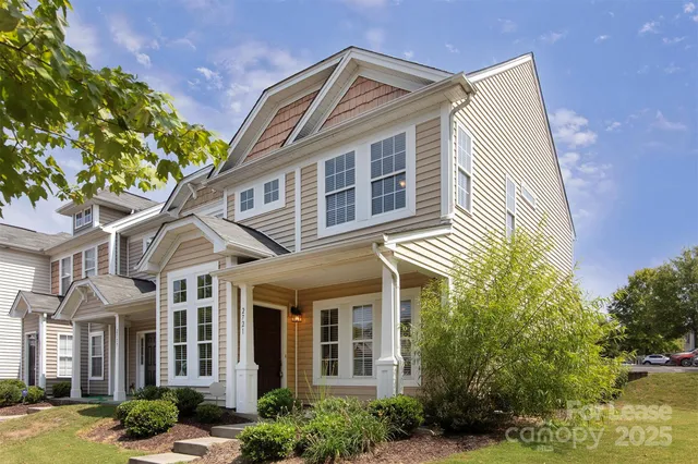 a view of a white house next to a yard