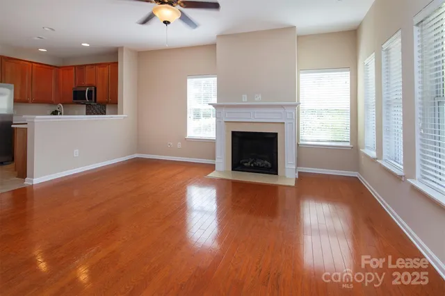 a view of a kitchen with a sink a fireplace and wooden floor