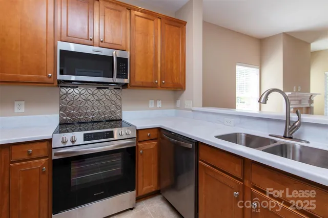 a kitchen with granite countertop a stove and a sink