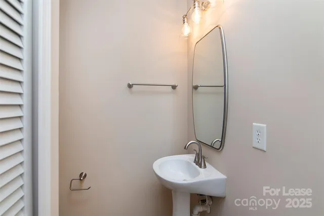 a bathroom with a sink and mirror