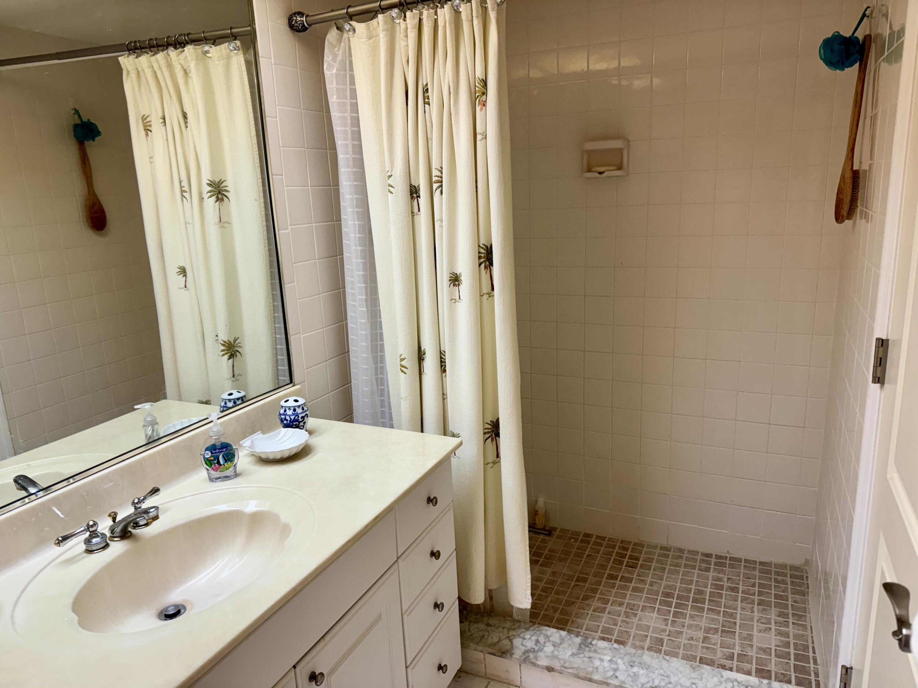 1868 Southwest Palm City Road, Unit 202 Stuart, FL 34994 - Photo 15 of 18 a bathroom with a sink and a mirror