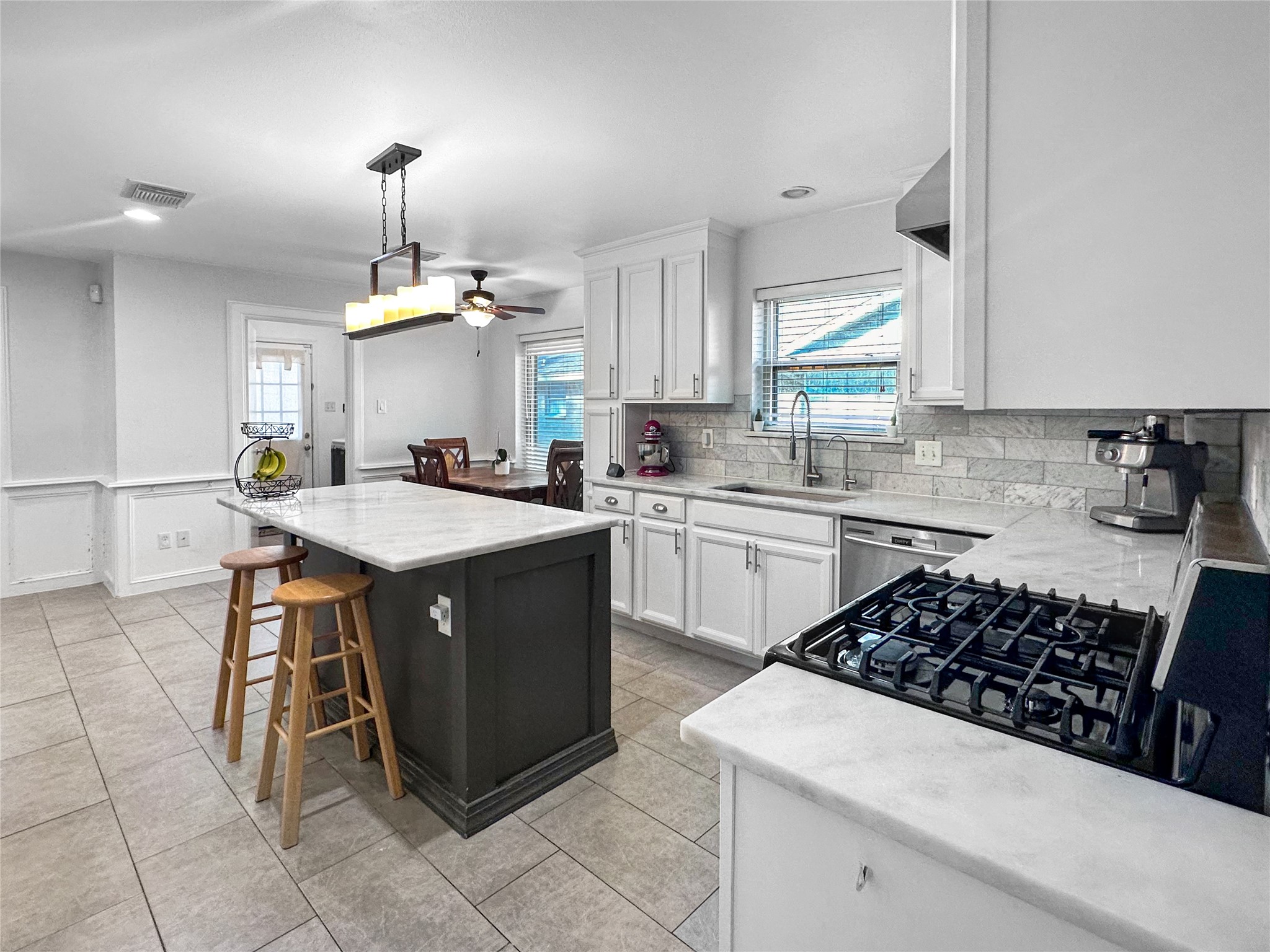 6511 Castle Pine Lane Spring, TX 77379 - Photo 16 of 49 Bright and functional kitchen showcasing abundant cabinetry, expansive counter space, and a center island designed for both meal preparation and entertaining.
