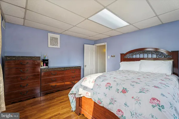 a bedroom with a bed and a dresser