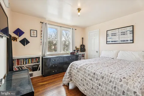 a bedroom with a bed and a large window