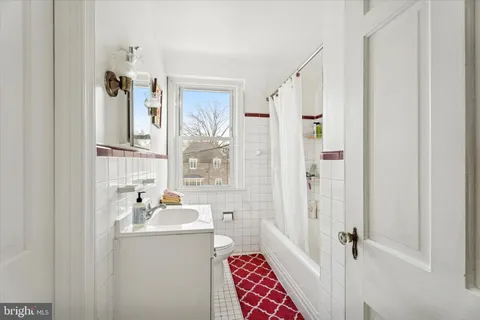 a bathroom with a sink a mirror a vanity and a shower