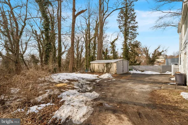 a backyard of a house with large trees