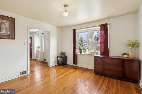 a view of a livingroom with wooden floor and furniture