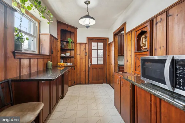 a hallway with stainless steel appliances granite countertop a washer and dryer