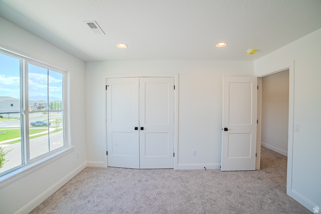 45 North Scarlet Maple Road, Unit 4317 Vineyard, UT 84059 - Photo 25 of 35 Spacious room featuring a large window, light-toned carpet, two panel doors with matte black hardware, and recessed lighting