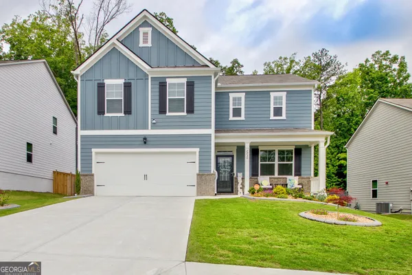 a front view of a house with a yard and garage