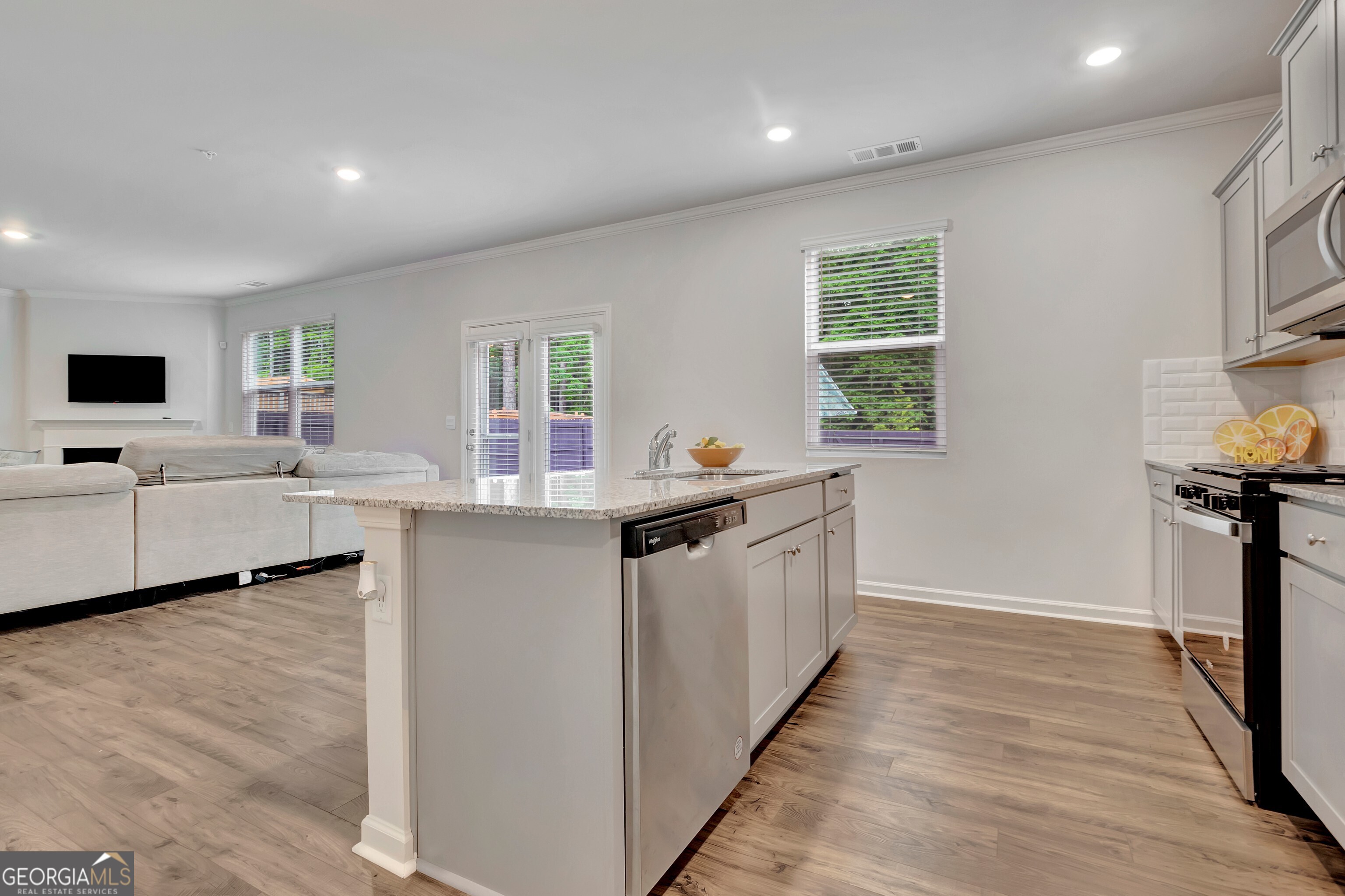 7730 Demeter Drive Fairburn, GA 30213 - Photo 15 of 47 a kitchen with white cabinets and sink