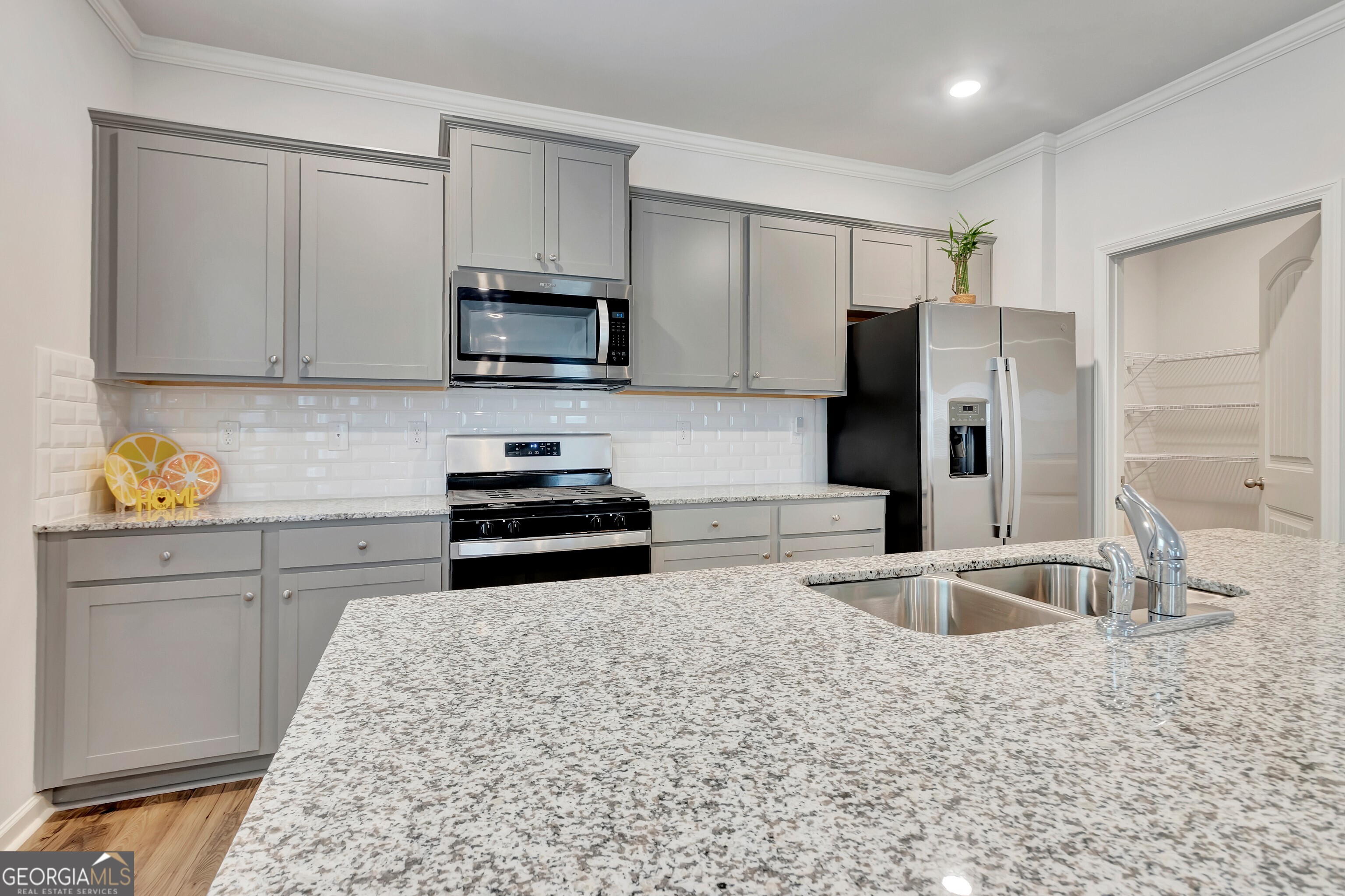 7730 Demeter Drive Fairburn, GA 30213 - Photo 18 of 47 a kitchen with stainless steel appliances granite countertop a refrigerator sink and stove