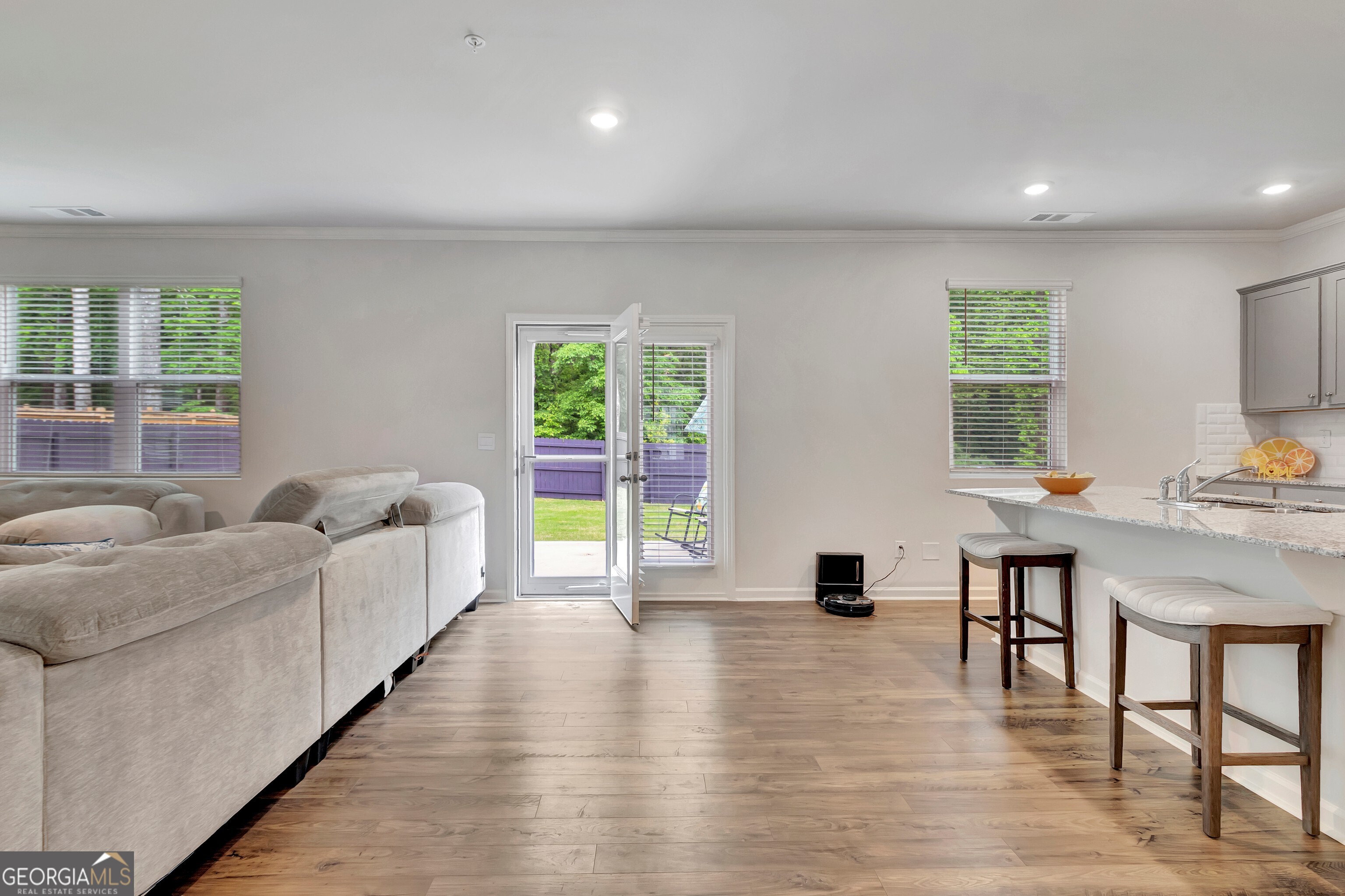 7730 Demeter Drive Fairburn, GA 30213 - Photo 19 of 47 a living room with furniture and a lamp