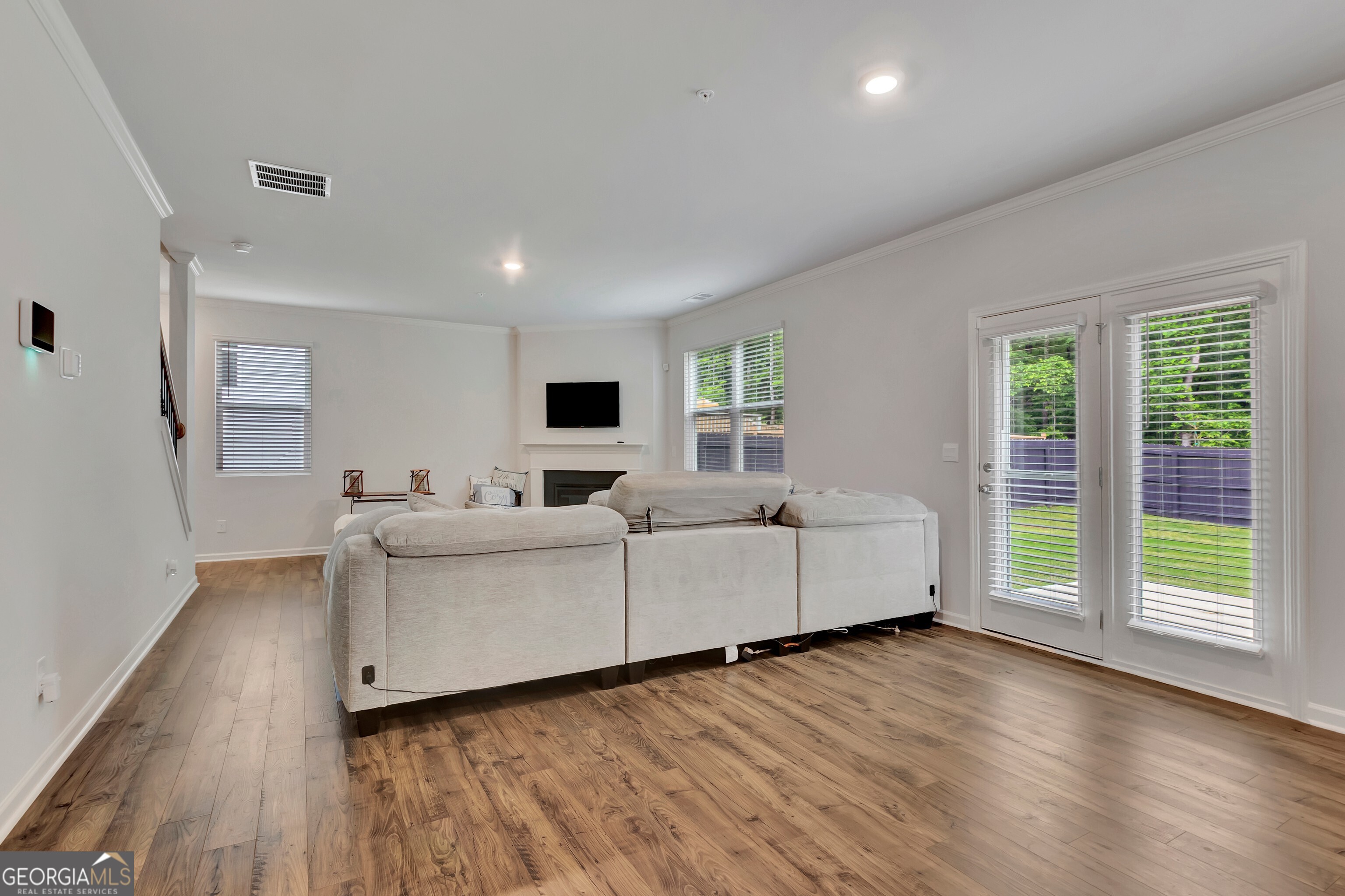 7730 Demeter Drive Fairburn, GA 30213 - Photo 20 of 47 a living room with furniture and large windows