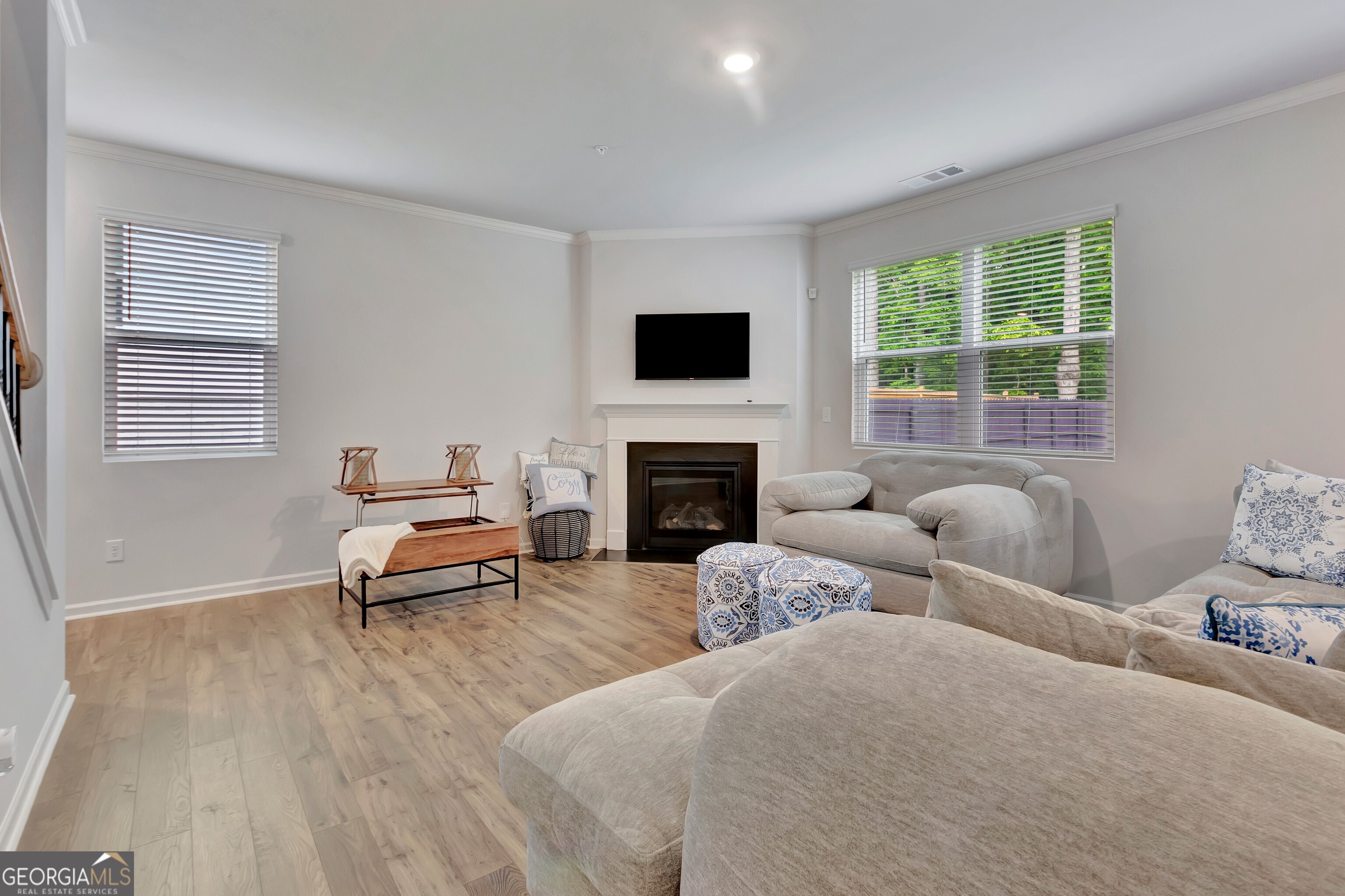 7730 Demeter Drive Fairburn, GA 30213 - Photo 21 of 47 a living room with furniture and a flat screen tv