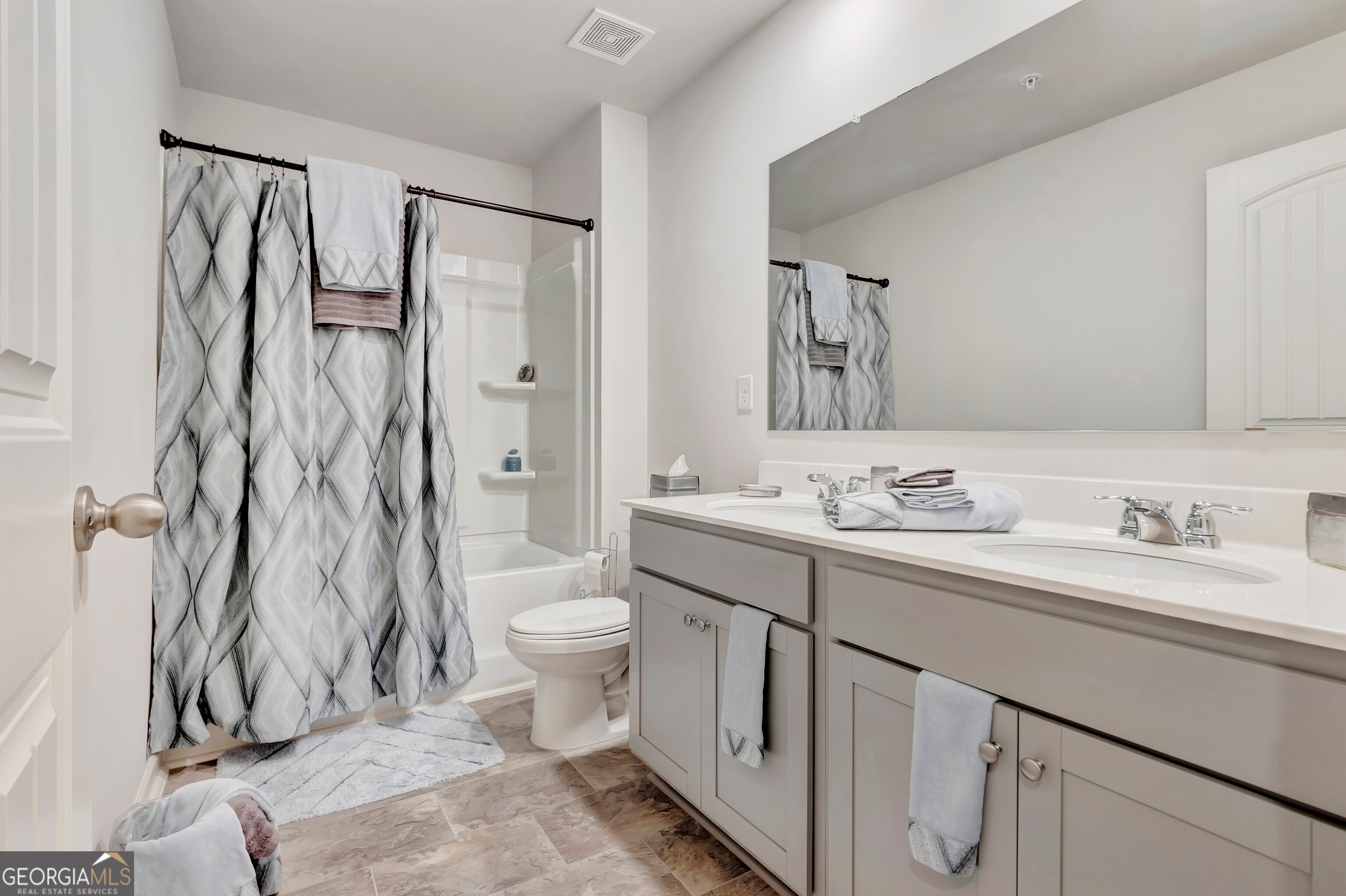 7730 Demeter Drive Fairburn, GA 30213 - Photo 28 of 47 a bathroom with a granite countertop sink toilet and shower