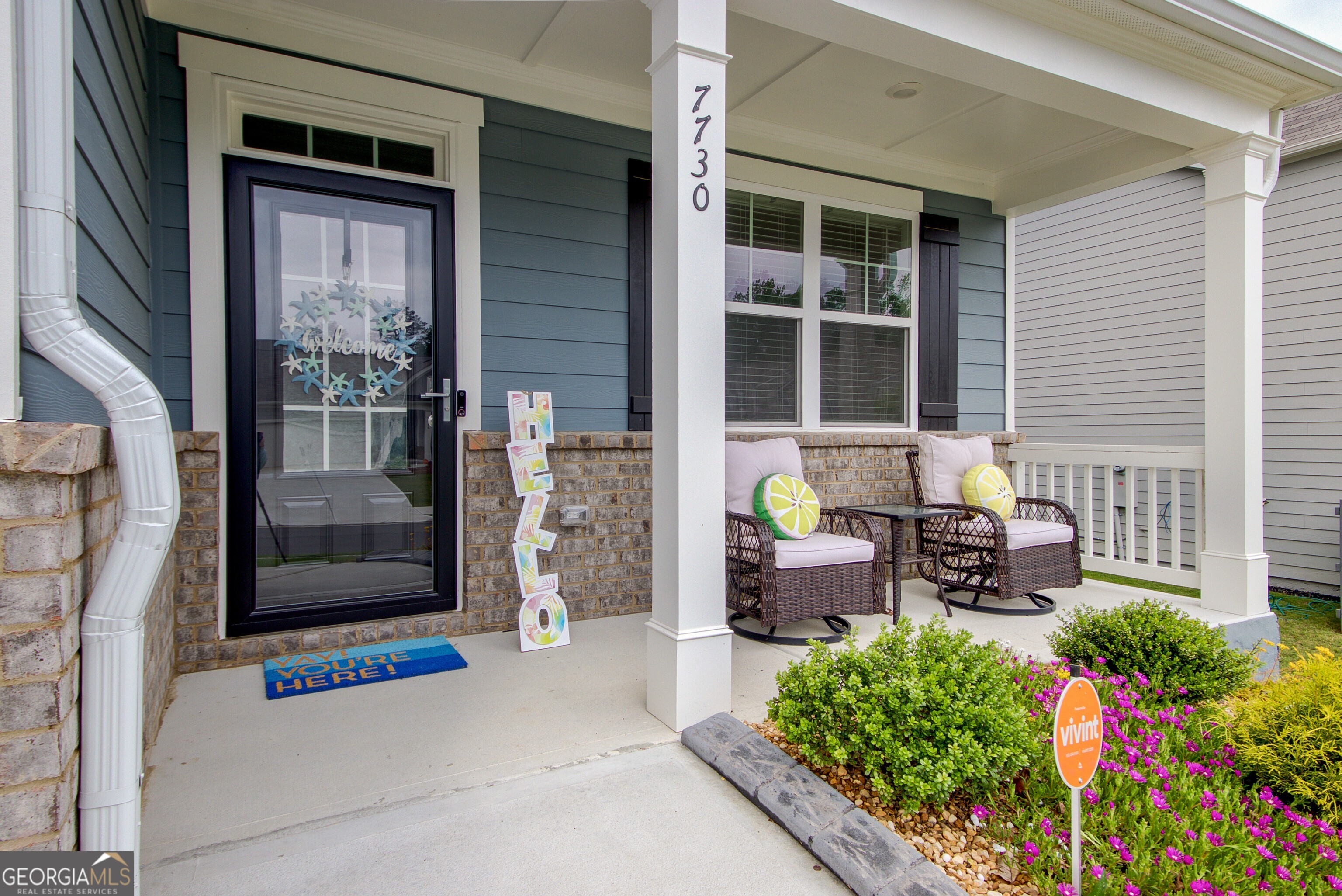 7730 Demeter Drive Fairburn, GA 30213 - Photo 5 of 47 a front view of a house with outdoor seating