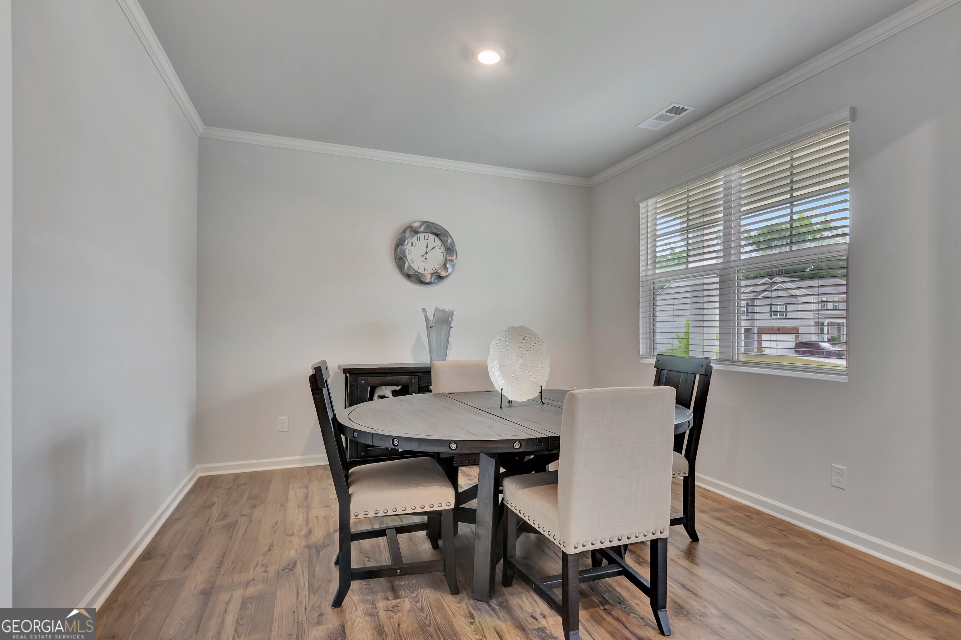 7730 Demeter Drive Fairburn, GA 30213 - Photo 9 of 47 a view of a dining room with furniture window and wooden floor