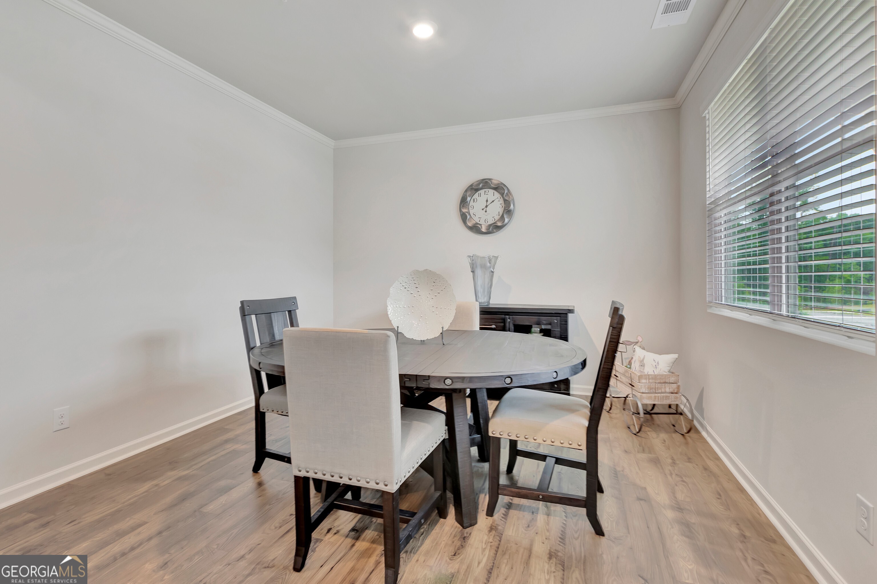 7730 Demeter Drive Fairburn, GA 30213 - Photo 10 of 47 a view of a dining room with furniture and wooden floor