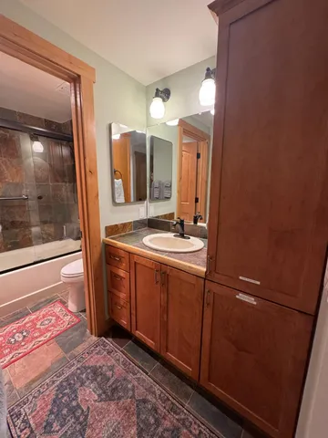a bathroom with a double vanity sink and mirror