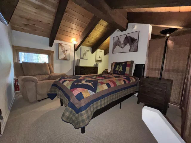 a bedroom with a bed couch and a dresser