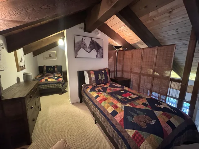 a bedroom with double bunk beds and a window
