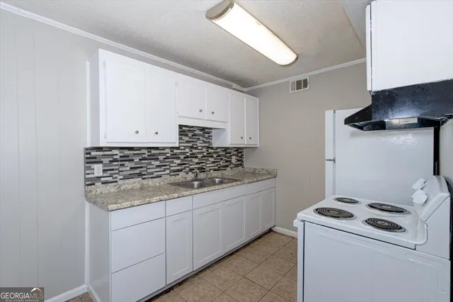 a kitchen with a stove and a sink