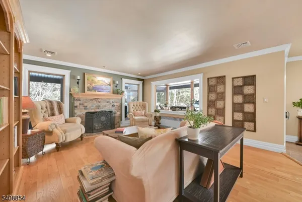 a living room with fireplace furniture and a large window