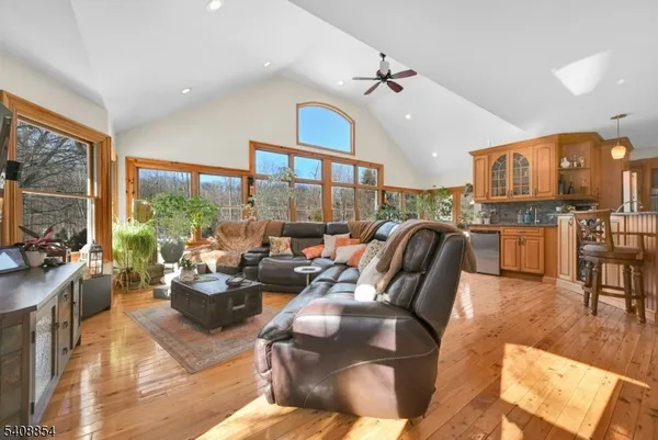 a living room with lots of furniture and a large window