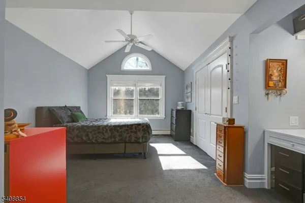 a bedroom with furniture and a window