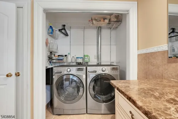a utility room with closet dryer and washer