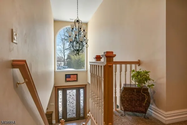 a view of a hallway with windows and stairs
