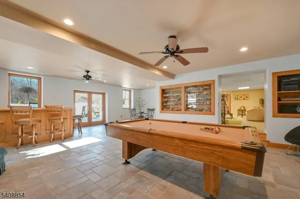 a room with pool table and windows