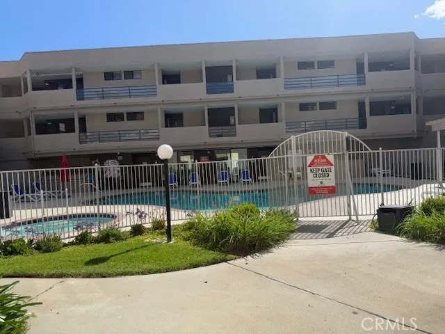 a view of a house with a yard and large trees