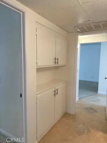 a front view of a house having patio with a garden