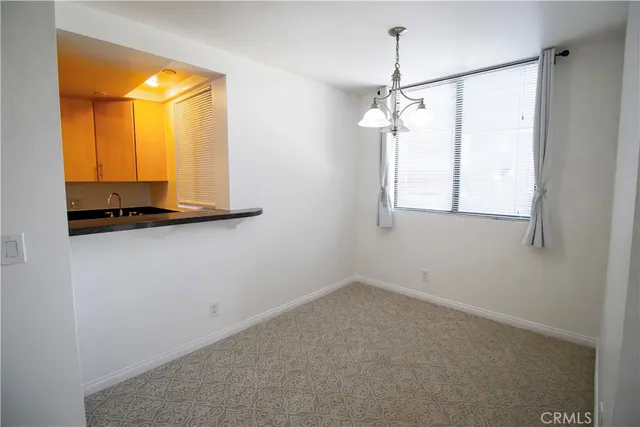 a kitchen with stainless steel appliances granite countertop a refrigerator a stove and a sink with wooden floor