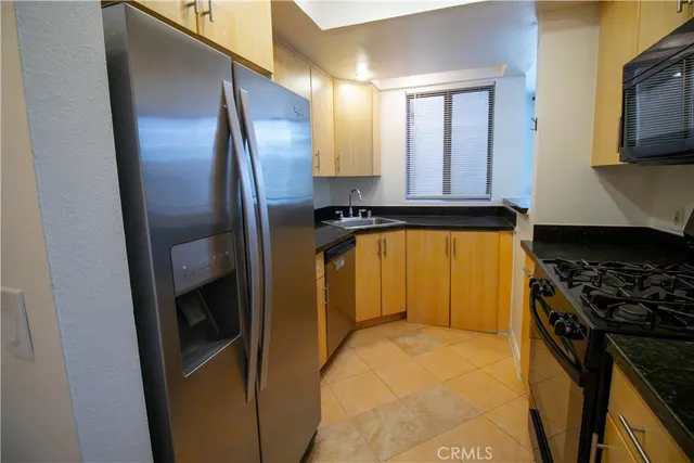 a view of a house with a yard and large trees