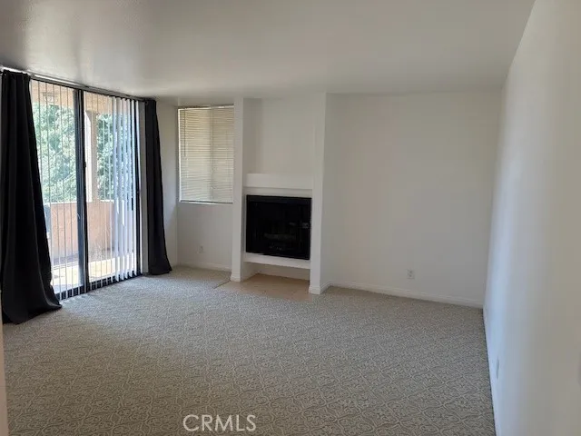 a view of a house with a yard and large trees