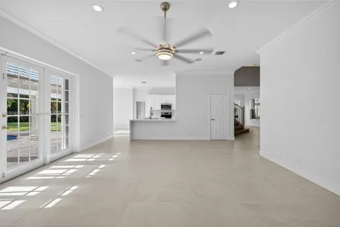 a view of a livingroom with a ceiling fan and window
