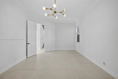 an empty room with closet and a ceiling fan