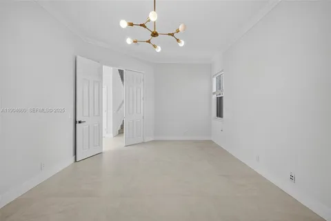 an empty room with closet and a ceiling fan