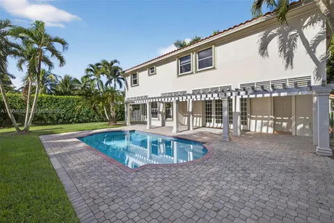 a view of a house with backyard and sitting area